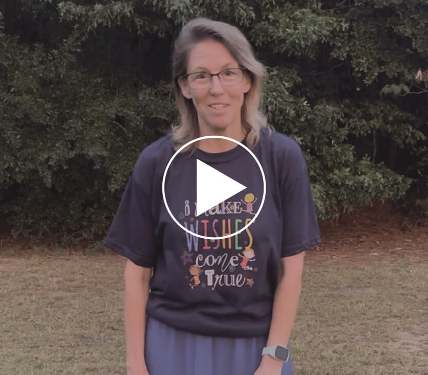 Donna standing outside of Faith Temple Church and a play video button